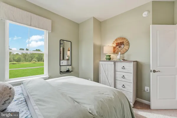a bedroom with a bed and a large window
