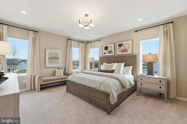 a spacious bedroom with a bed and a chandelier