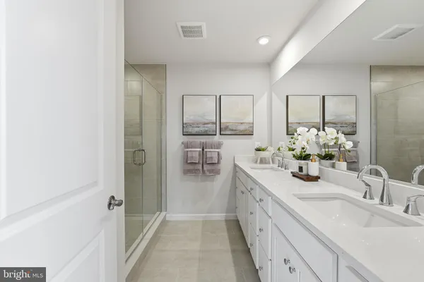 a bathroom with a double vanity sink and a mirror