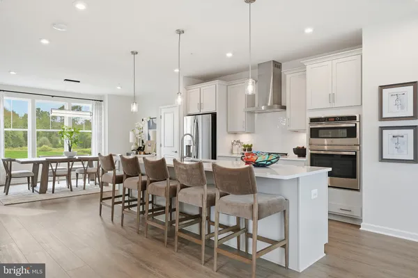 a large kitchen with a table and chairs