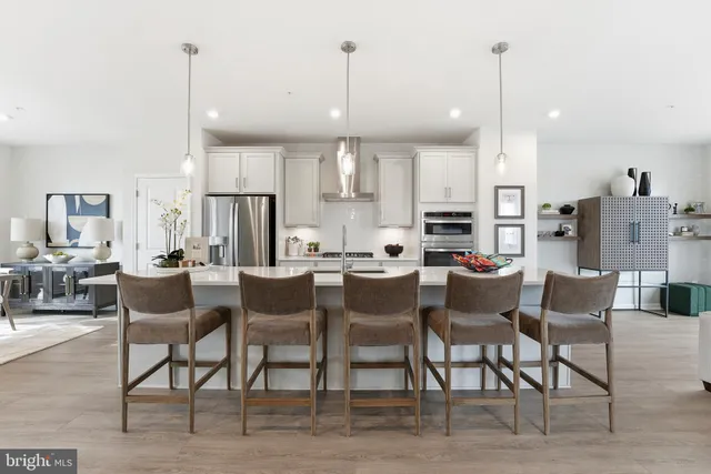 a large kitchen with a table and chairs
