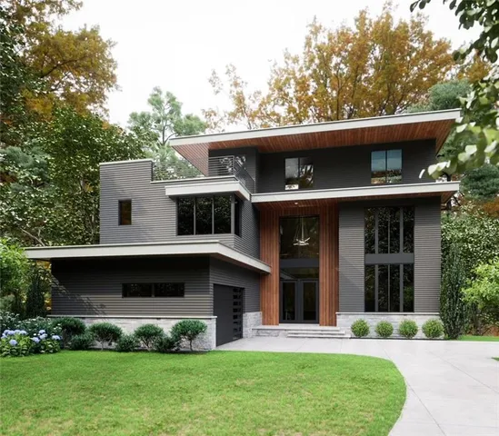 a view of a house with a yard and a large tree