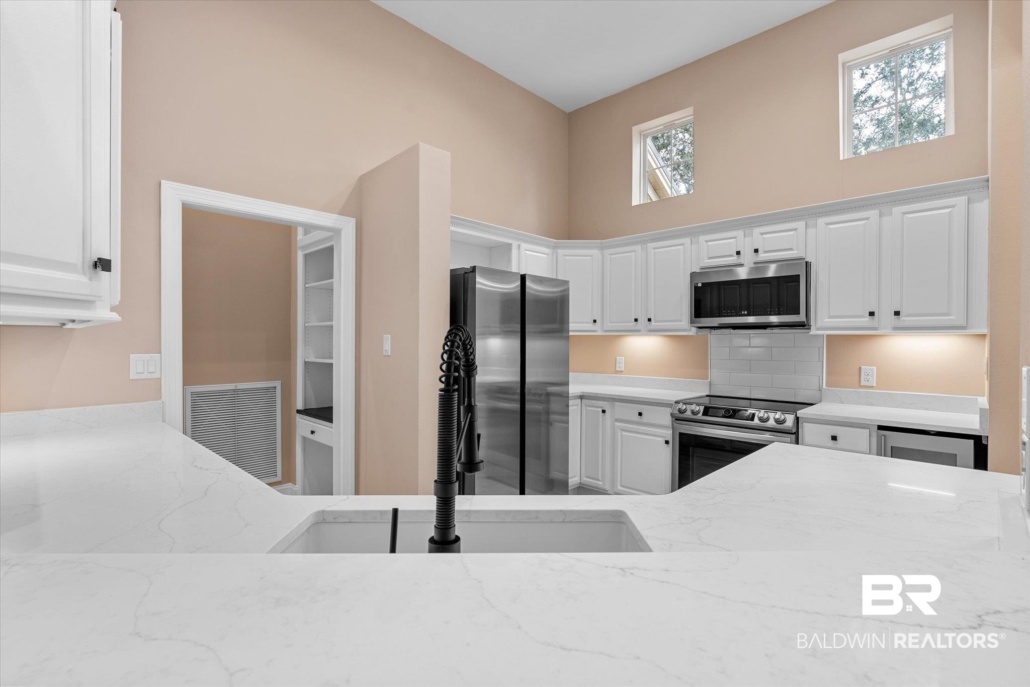 9259 Genipa Way Gulf Shores, AL 36542 - Photo 14 of 72 Kitchen featuring white cabinets, appliances with stainless steel finishes, and sink