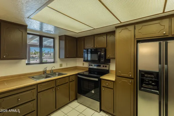 a kitchen with stainless steel appliances a sink stove and refrigerator