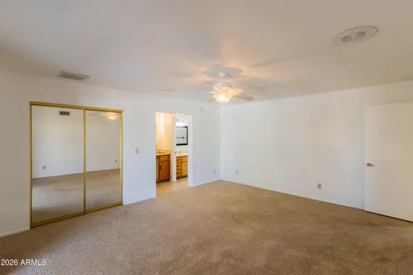 an empty room with closet area