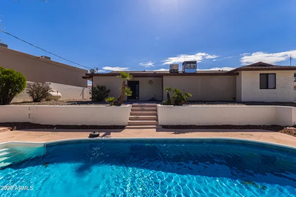 a view of a terrace with lawn chairs