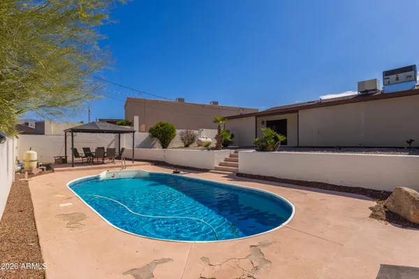 a view of a swimming pool with an outdoor seating