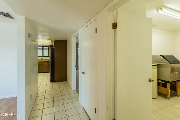 a view of a hallway with wooden shelves