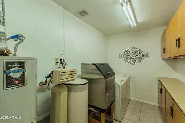 a view of storage and utility room with a window