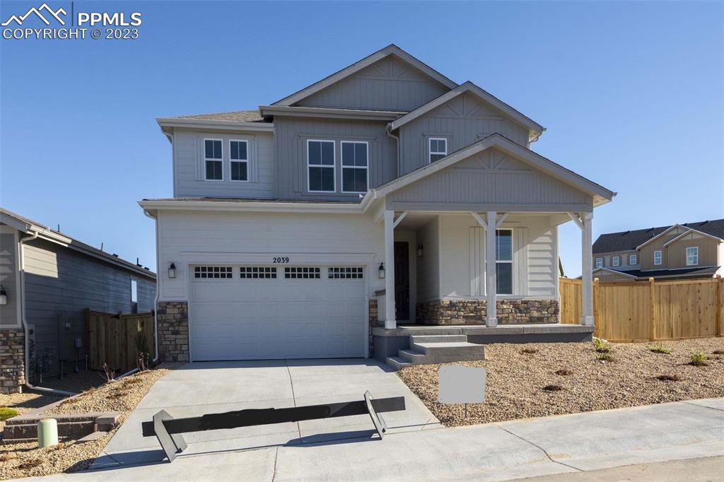 a front view of a house with garage