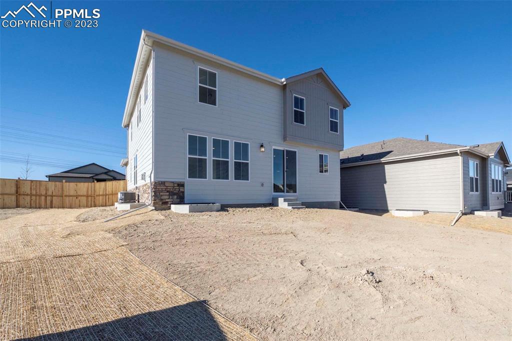 2039 Peachleaf Loop Castle Rock, CO 80108 - Photo 23 of 23 a view of a white house with a yard