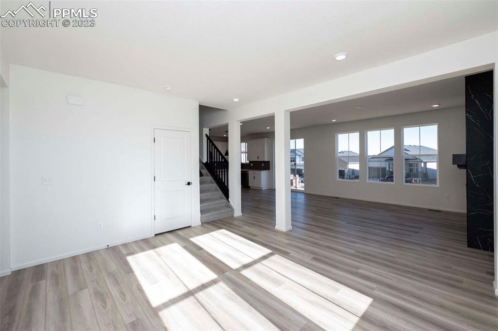 2039 Peachleaf Loop Castle Rock, CO 80108 - Photo 4 of 23 a view of an empty room with wooden floor and a window