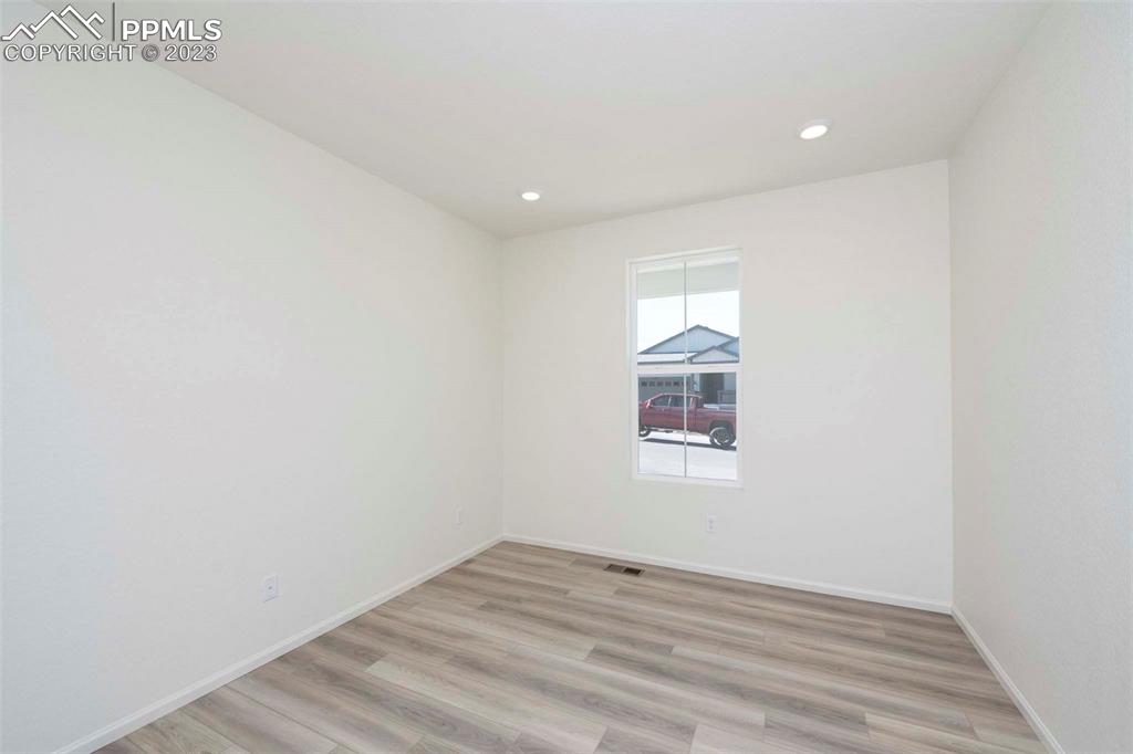 2039 Peachleaf Loop Castle Rock, CO 80108 - Photo 5 of 23 a view of an empty room with wooden floor and a window