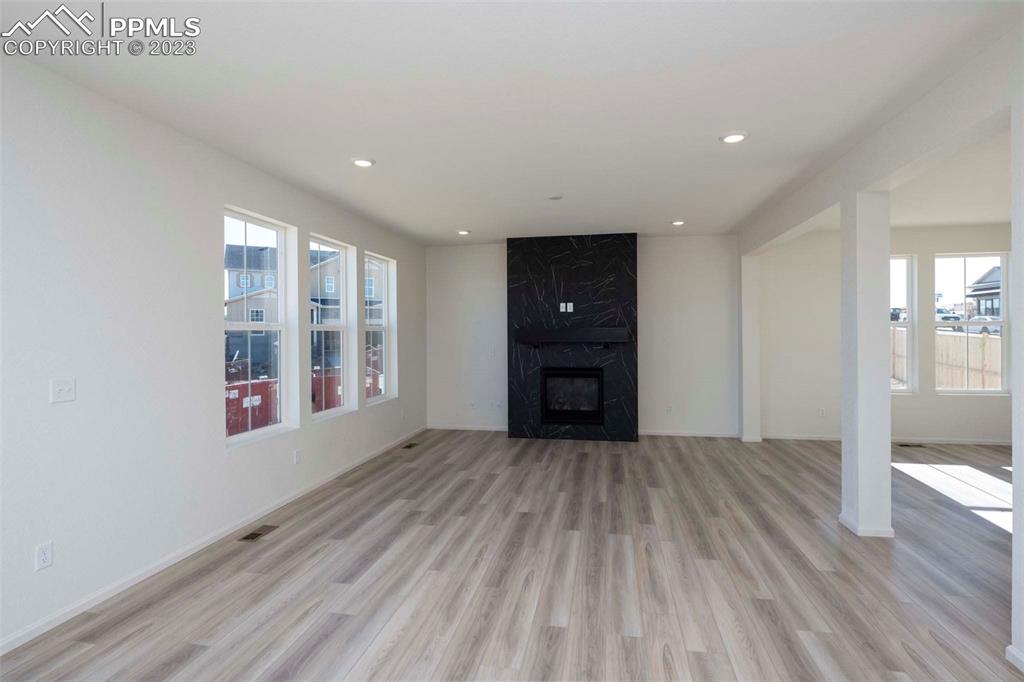 2039 Peachleaf Loop Castle Rock, CO 80108 - Photo 7 of 23 wooden floor in an empty room with a window