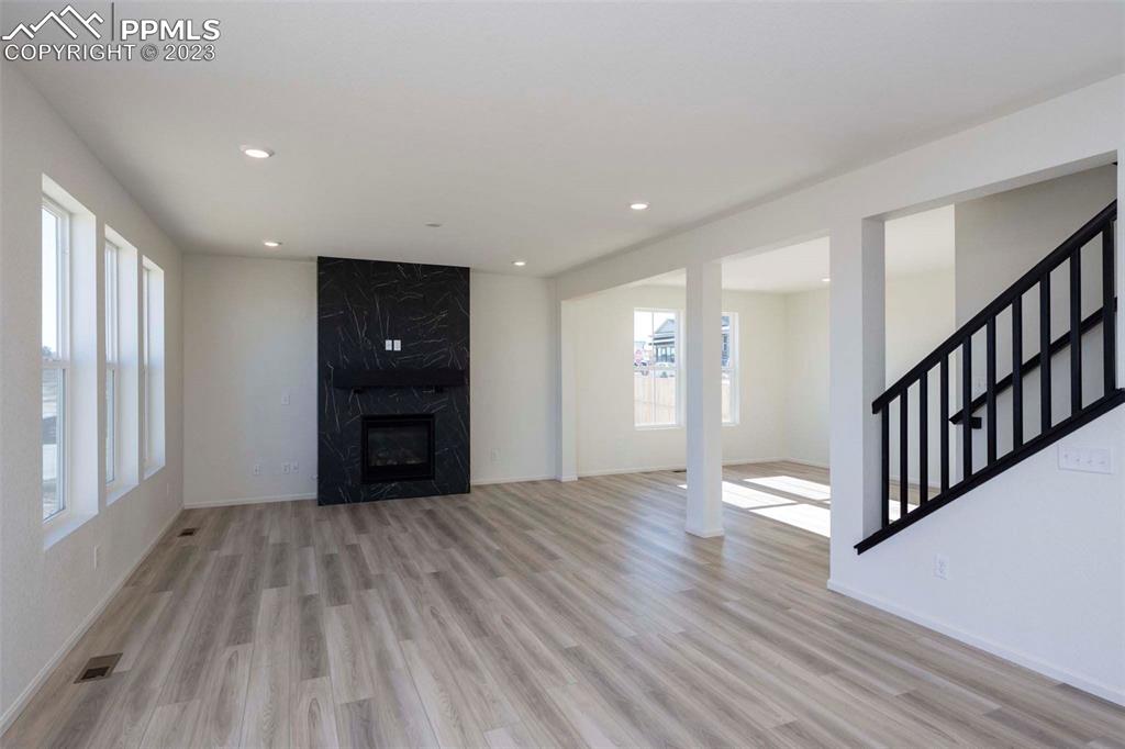 2039 Peachleaf Loop Castle Rock, CO 80108 - Photo 8 of 23 a view of an empty room with a window and wooden floor