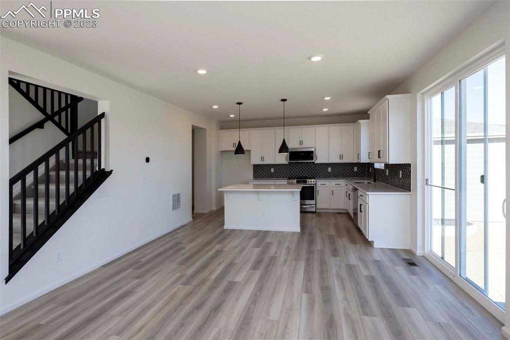 2039 Peachleaf Loop Castle Rock, CO 80108 - Photo 10 of 23 a kitchen with a white stove top oven and cabinets