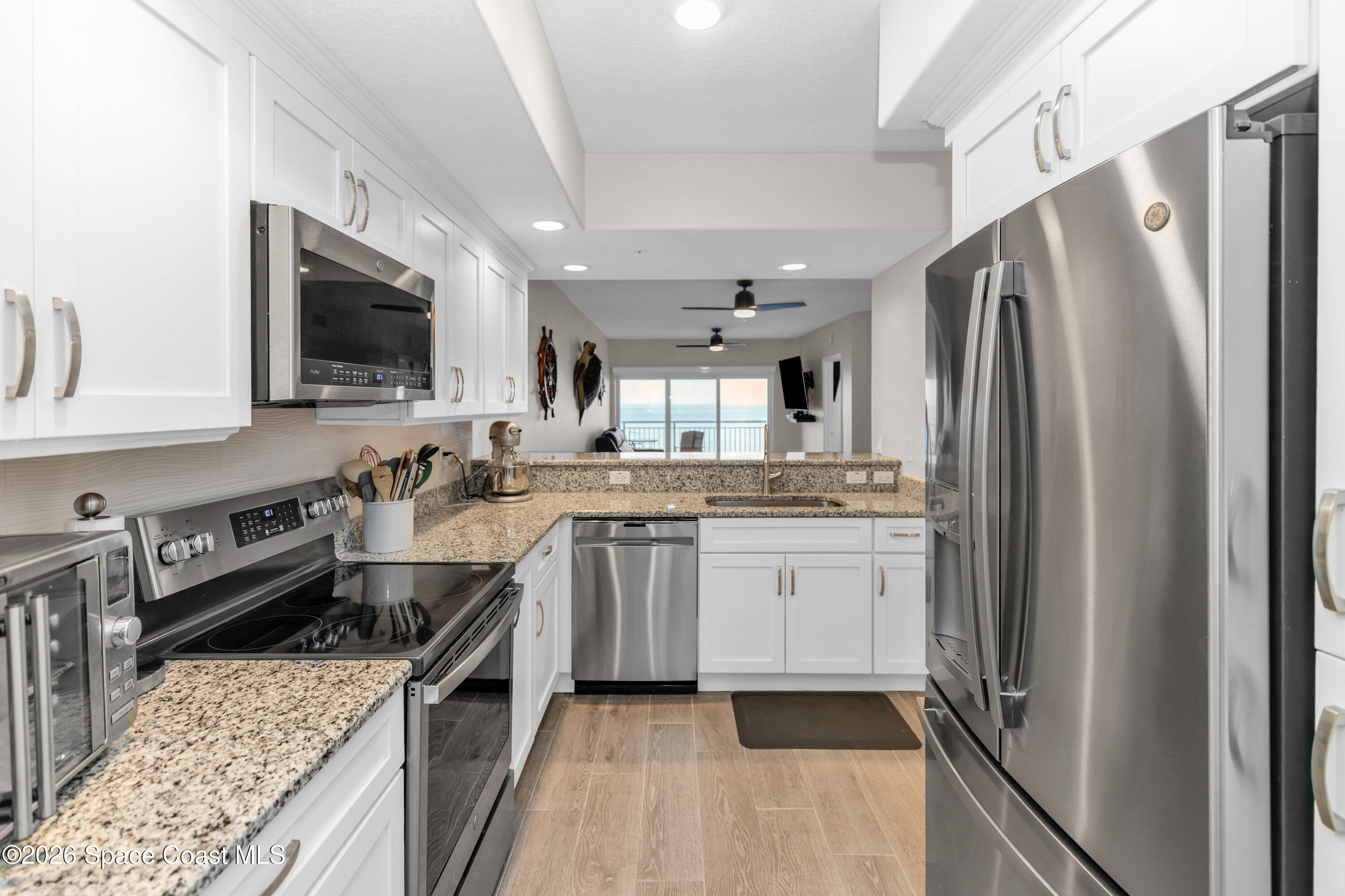 1805 Riverside Drive, Unit 506 Titusville, FL 32780 - Photo 7 of 24 a kitchen with stainless steel appliances granite countertop a refrigerator stove and sink