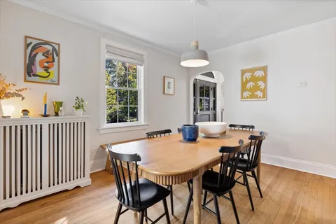 a dining room with furniture wooden floor and a rug