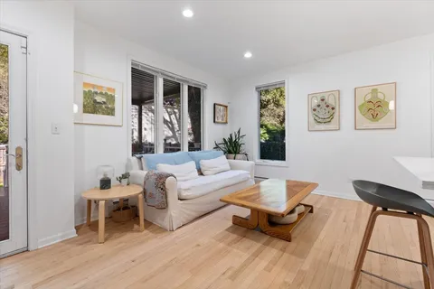 a living room with furniture and a wooden floor