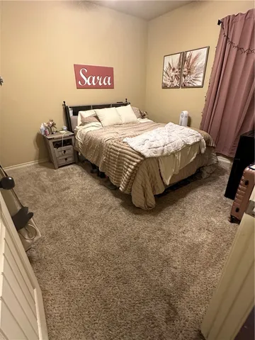 a bedroom with a bed and a dresser in it