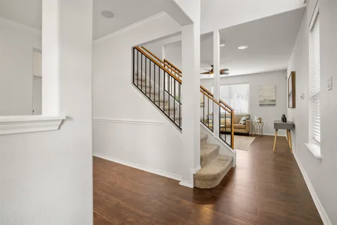 a view of entryway and hall with wooden floor