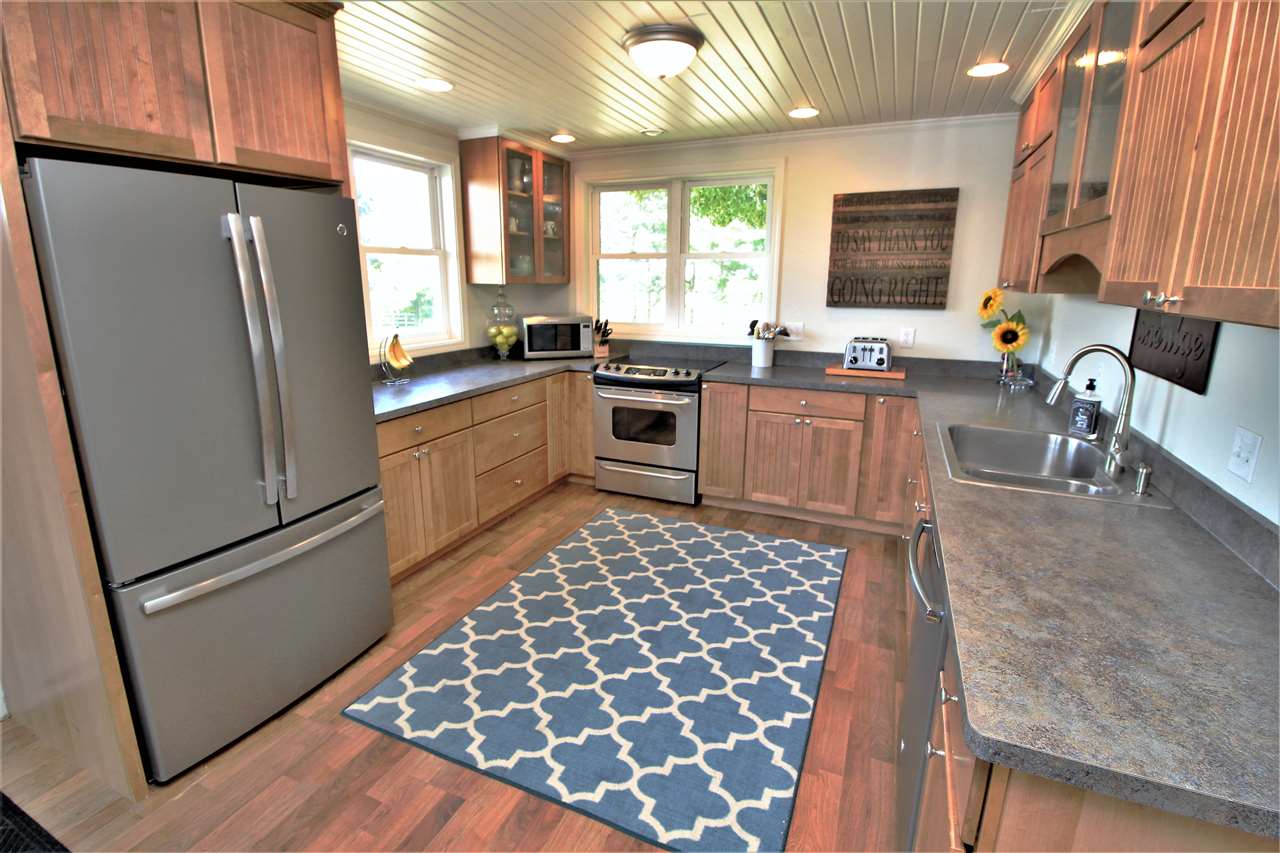 20152 Free Church Road Caledonia, IL 61011 - Photo 8 of 25 a kitchen with granite countertop stainless steel appliances a refrigerator sink and microwave