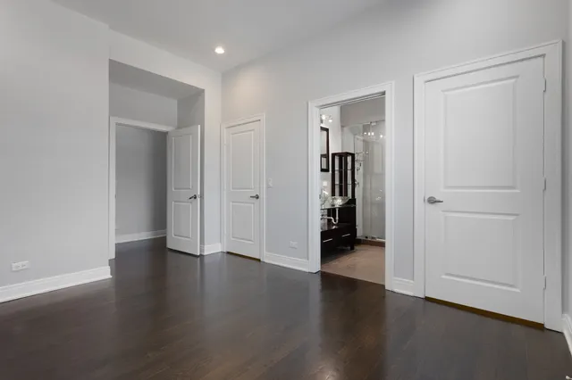 an empty room with wooden floor & closet