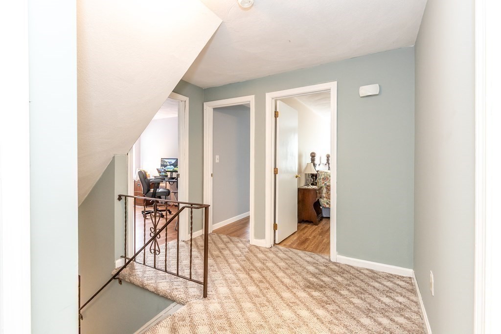 8 Comanche Circle Billerica, MA 01821 - Photo 15 of 35 a view of a hallway with wooden floor and dining room