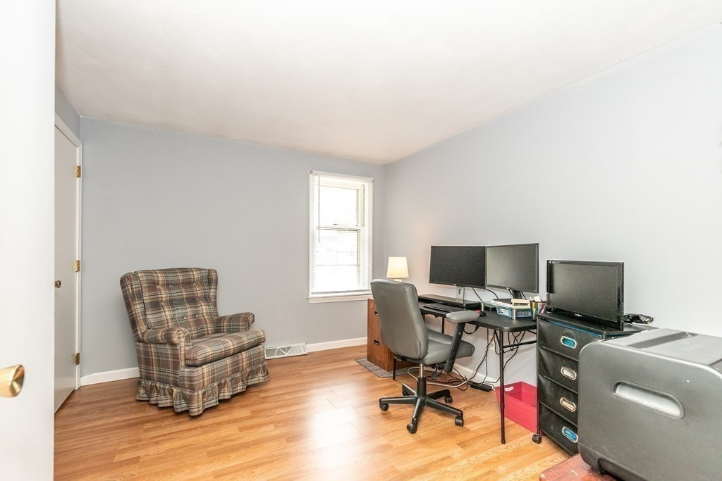 8 Comanche Circle Billerica, MA 01821 - Photo 19 of 35 a living room with furniture and a flat screen tv