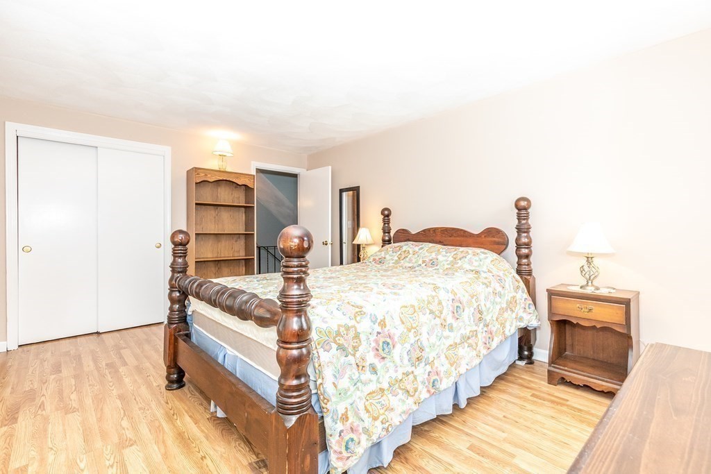 8 Comanche Circle Billerica, MA 01821 - Photo 20 of 35 a bedroom with a bed and wooden floor