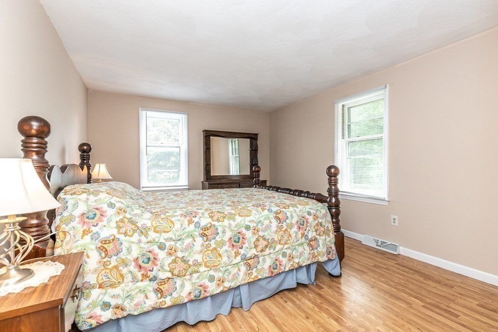 8 Comanche Circle Billerica, MA 01821 - Photo 21 of 35 a bed sitting in a bedroom next to a window and dresser