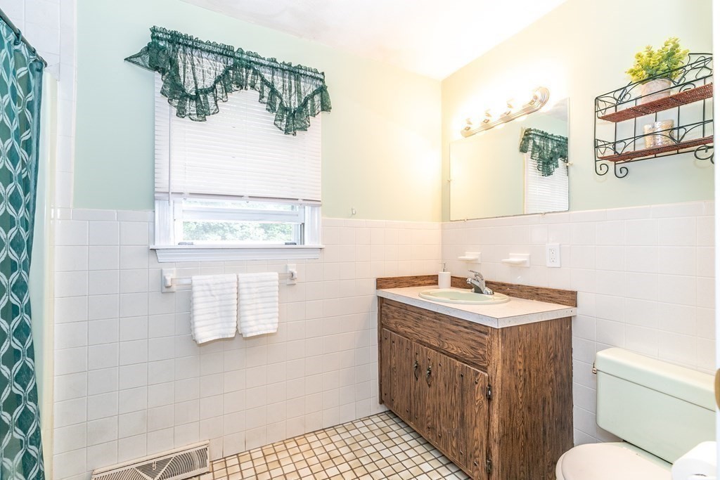 8 Comanche Circle Billerica, MA 01821 - Photo 24 of 35 a bathroom with a sink a mirror and a toilet