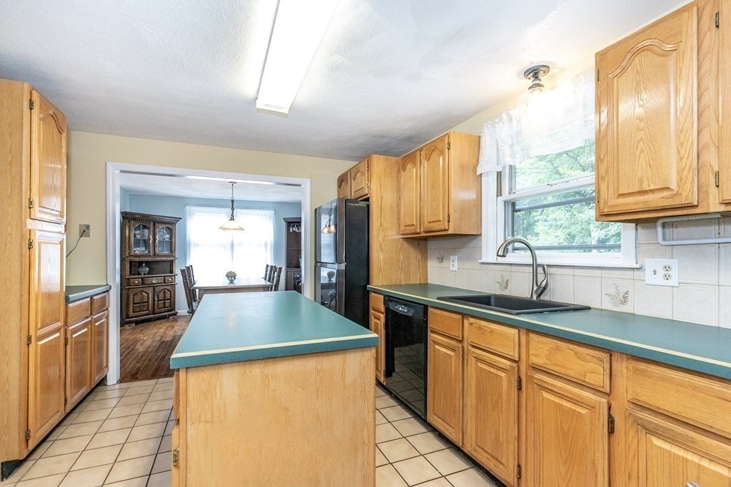 8 Comanche Circle Billerica, MA 01821 - Photo 3 of 35 a kitchen with stainless steel appliances granite countertop a sink a stove and a refrigerator