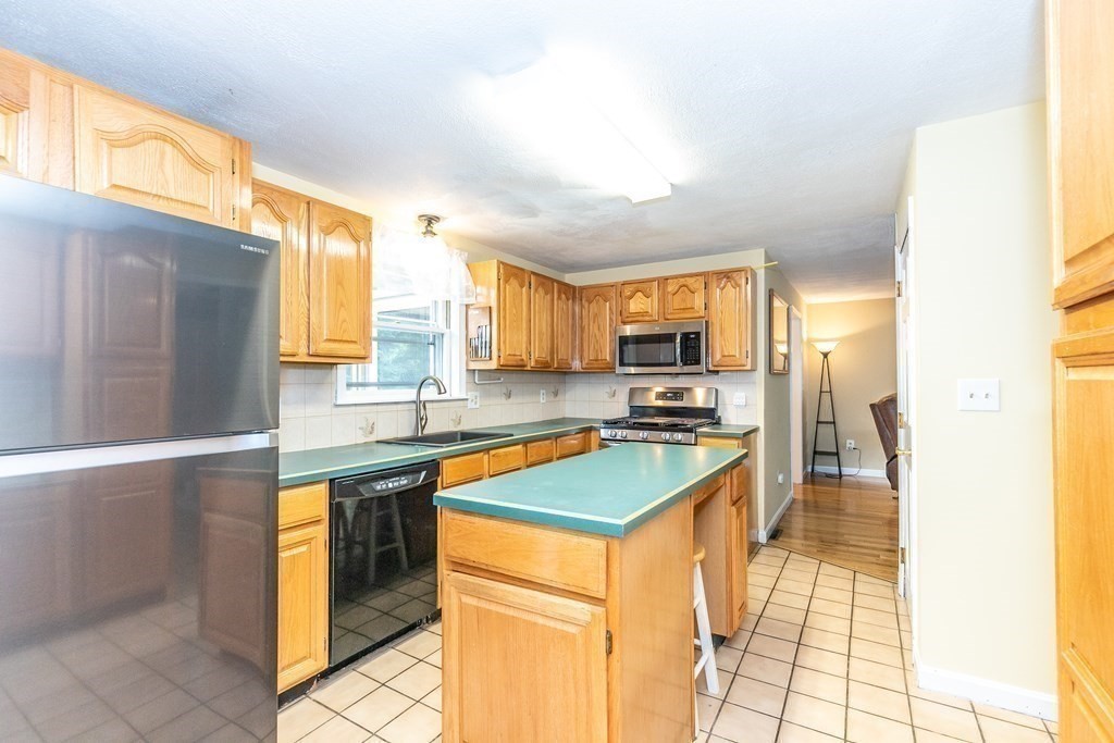 8 Comanche Circle Billerica, MA 01821 - Photo 5 of 35 a kitchen with stainless steel appliances granite countertop sink stove and refrigerator