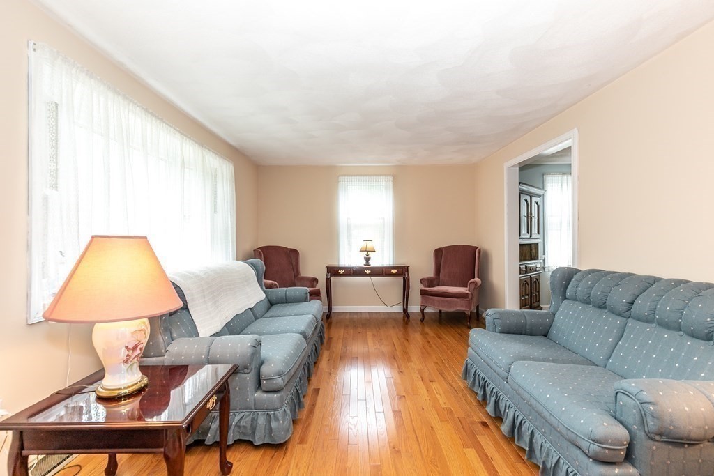 8 Comanche Circle Billerica, MA 01821 - Photo 10 of 35 a living room with furniture and a lamp