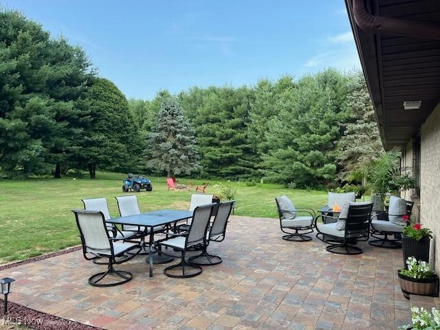 5795 Merwin Chase Road Brookfield, OH 44403 - Photo 39 of 39 View of patio / terrace featuring outdoor dining space and a view of trees