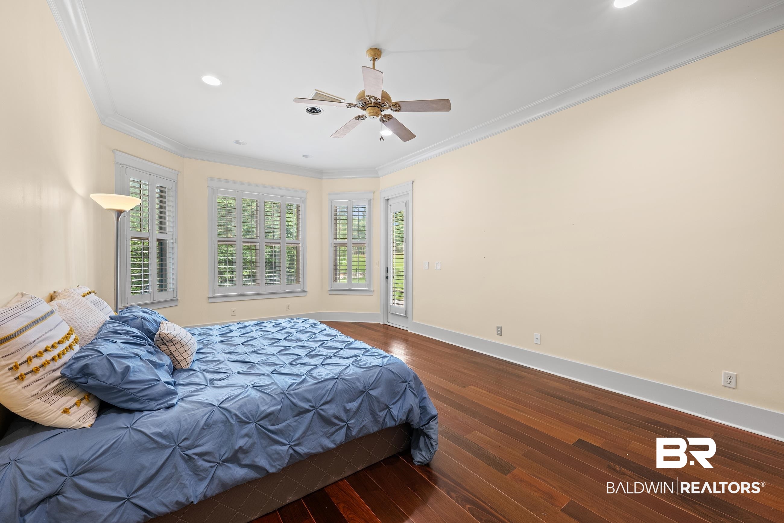 30463 Dolive Ridge Daphne, AL 36527 - Photo 46 of 58 Spacious room featuring wood-finish flooring, multiple windows with plantation shutters, a ceiling fan, recessed lighting, and crown molding