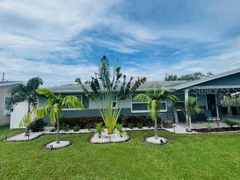 a view of a house with backyard porch and sitting area