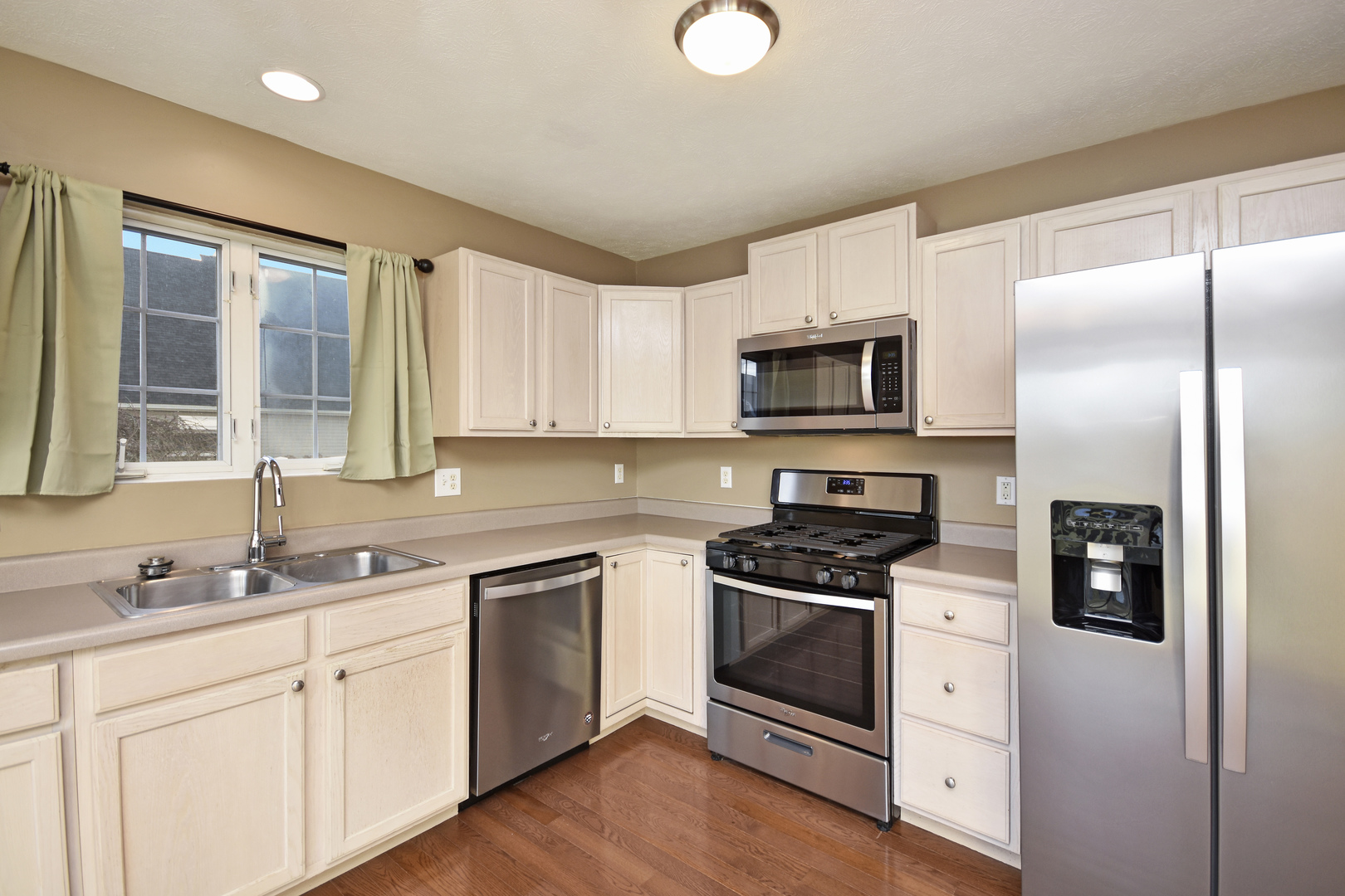 5 Andy Court, Unit 4 Bloomington, IL 61704 - Photo 12 of 52 a kitchen with white cabinets and stainless steel appliances