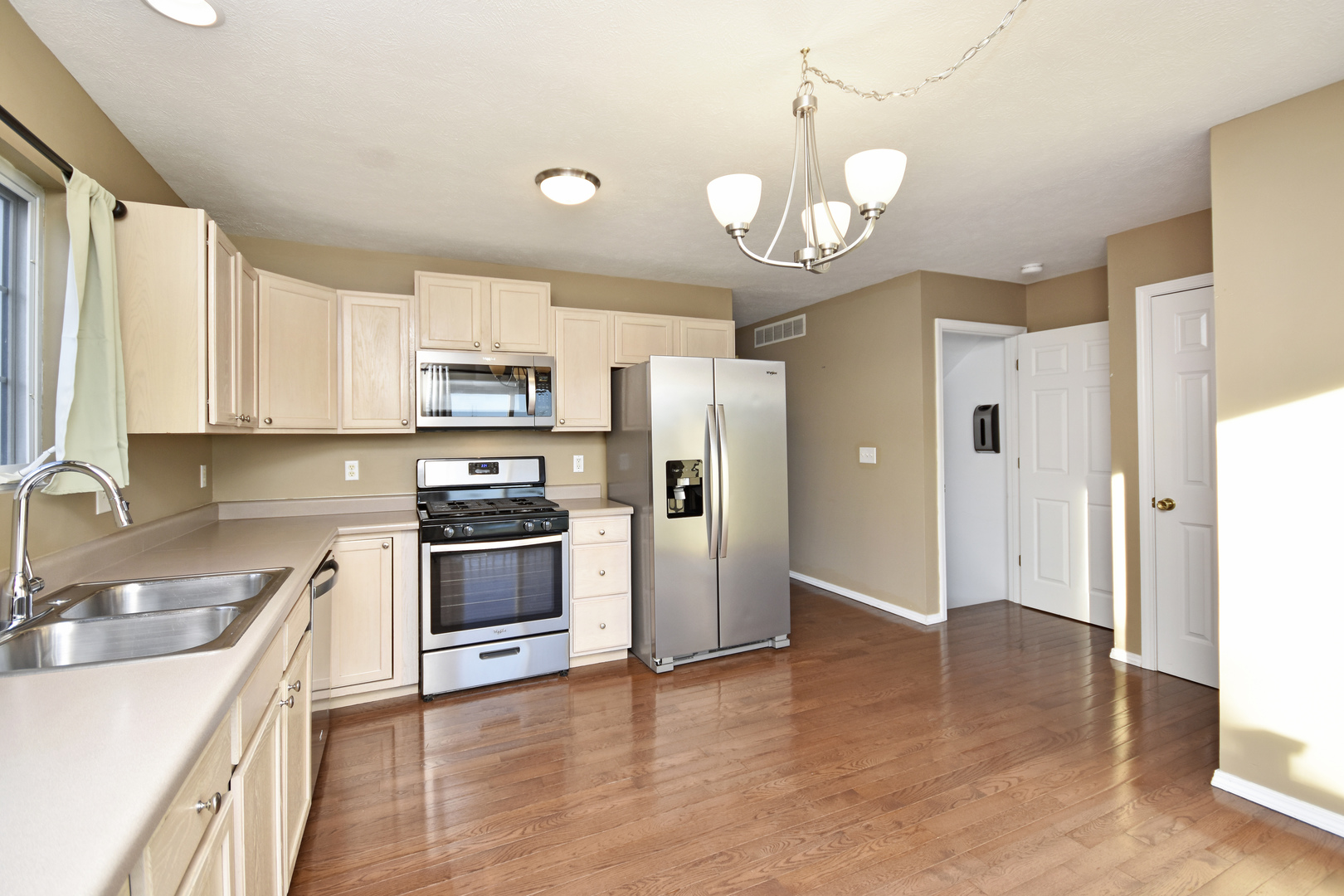 5 Andy Court, Unit 4 Bloomington, IL 61704 - Photo 14 of 52 a kitchen with a sink stainless steel appliances and cabinets