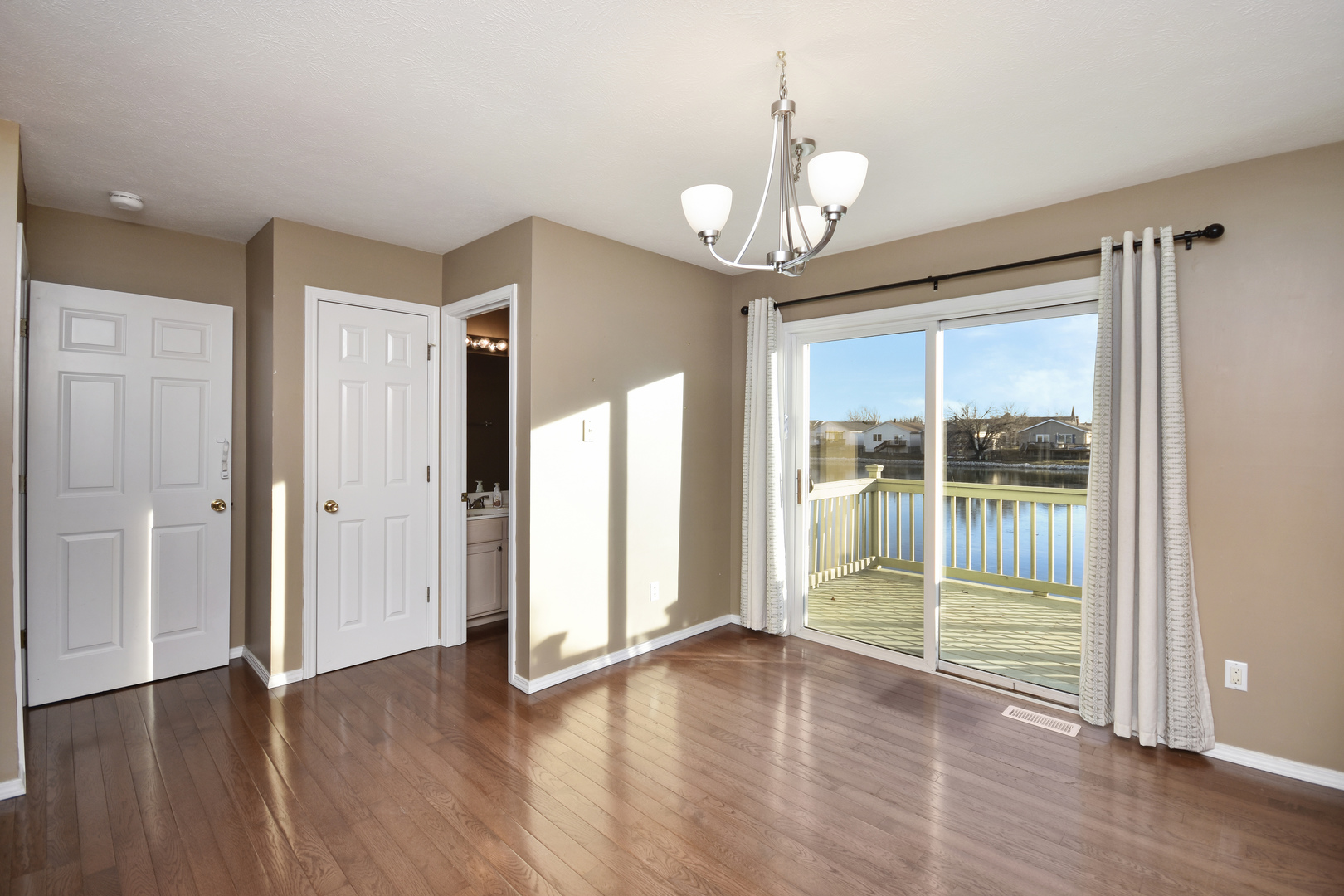 5 Andy Court, Unit 4 Bloomington, IL 61704 - Photo 15 of 52 a view of an empty room with wooden floor and a window