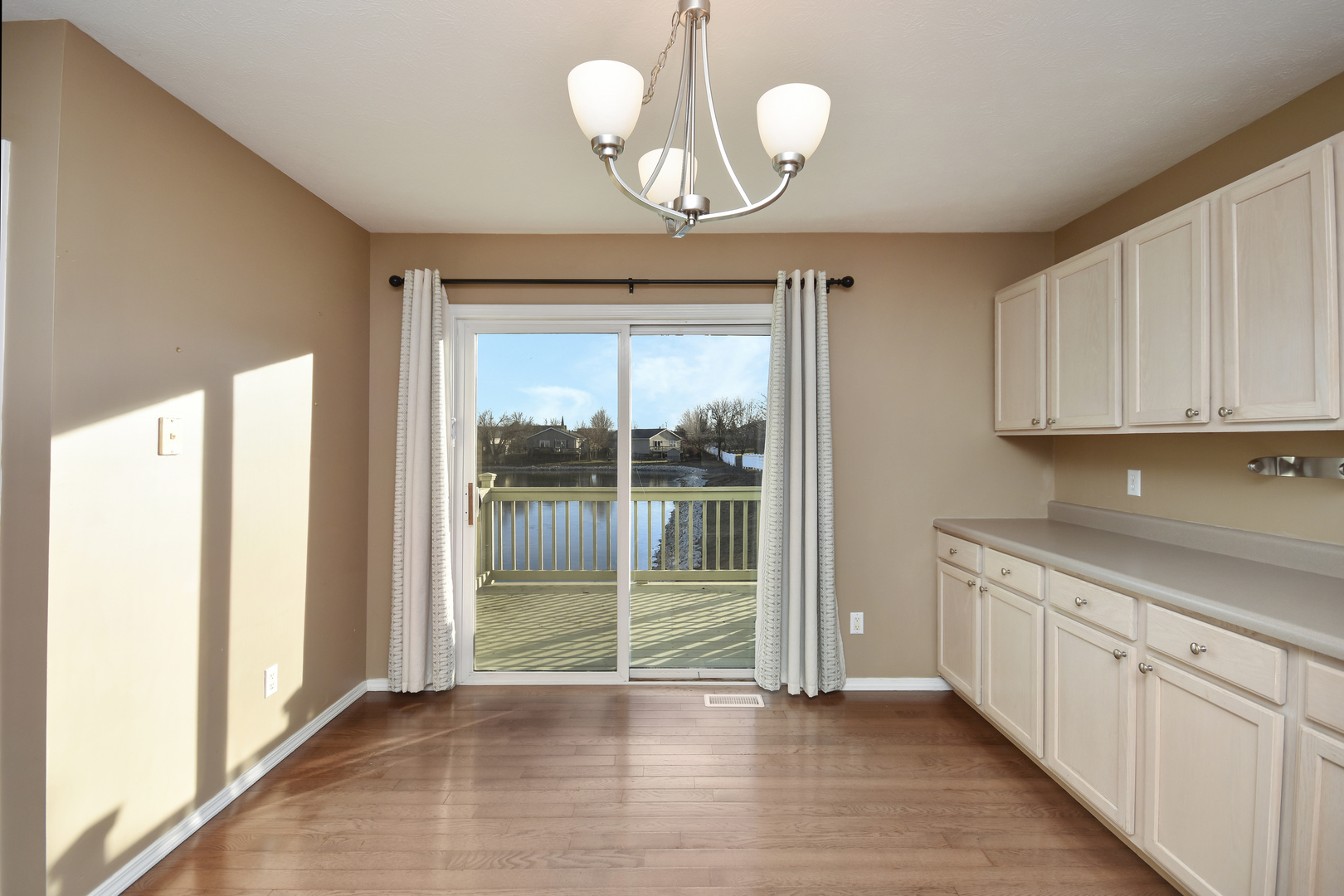 5 Andy Court, Unit 4 Bloomington, IL 61704 - Photo 16 of 52 a view of an empty room with wooden floor and a window