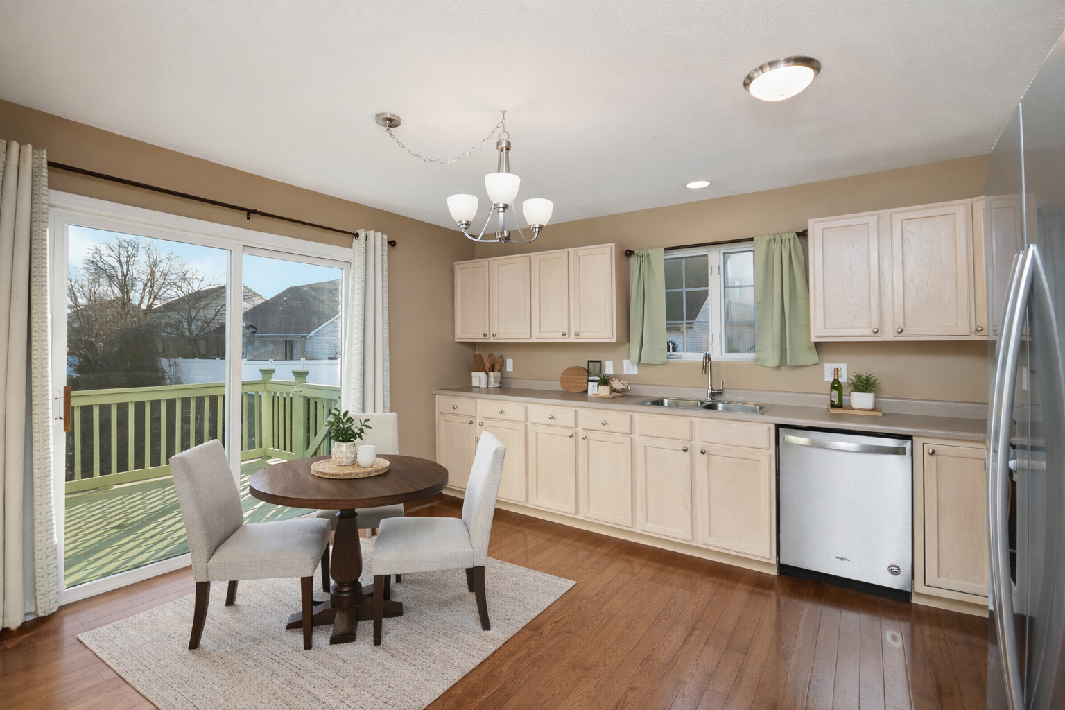 5 Andy Court, Unit 4 Bloomington, IL 61704 - Photo 18 of 52 a kitchen with granite countertop white cabinets stainless steel appliances dining table and chairs