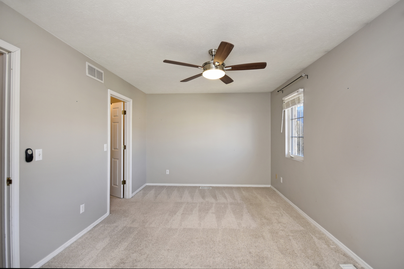 5 Andy Court, Unit 4 Bloomington, IL 61704 - Photo 22 of 52 a view of room with a ceiling fan and window