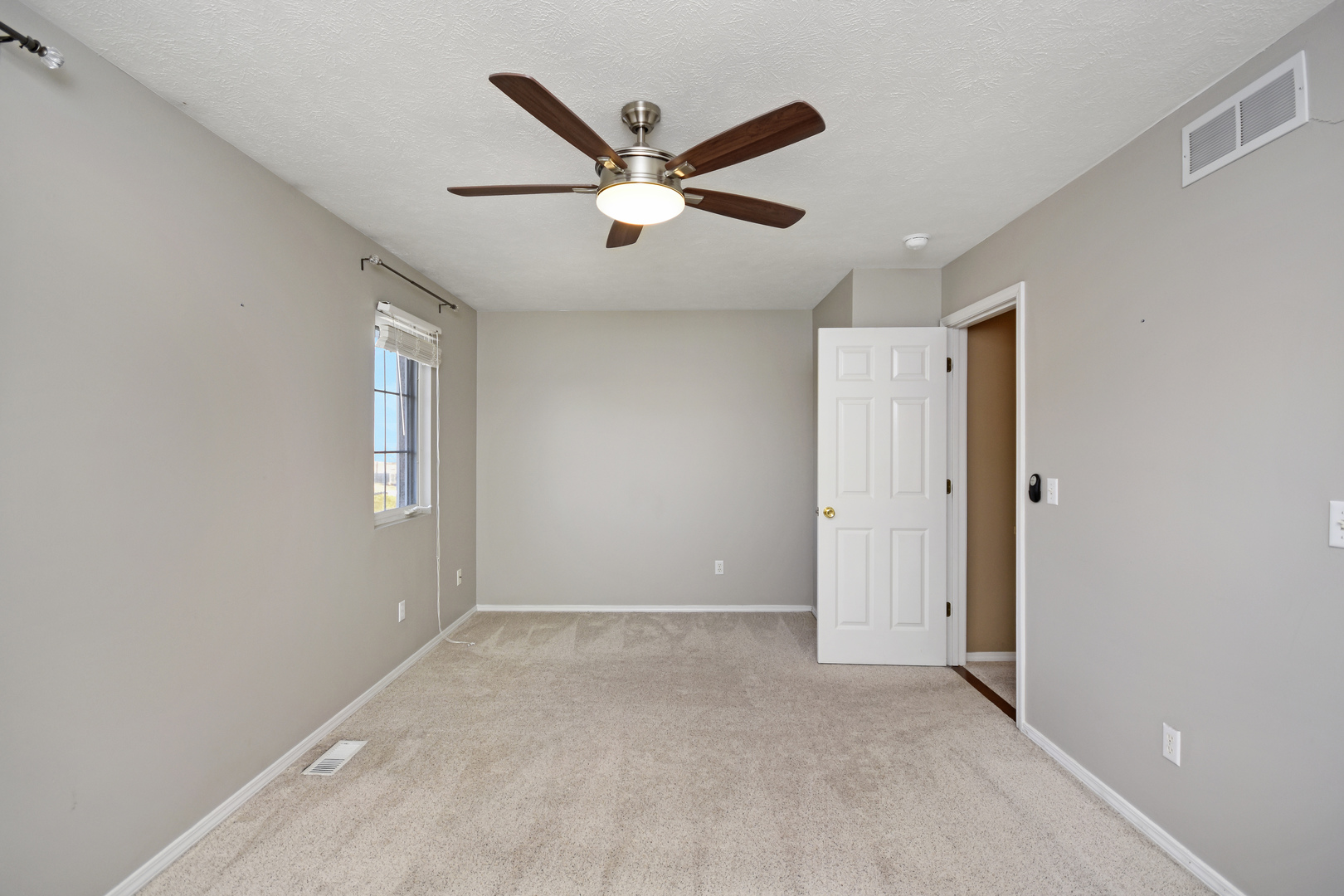 5 Andy Court, Unit 4 Bloomington, IL 61704 - Photo 24 of 52 a view of an empty room with a ceiling fan