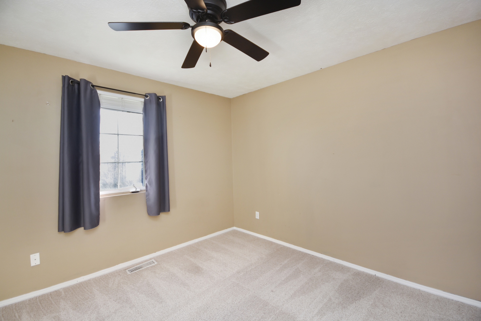 5 Andy Court, Unit 4 Bloomington, IL 61704 - Photo 29 of 52 an empty room with a window and a fan