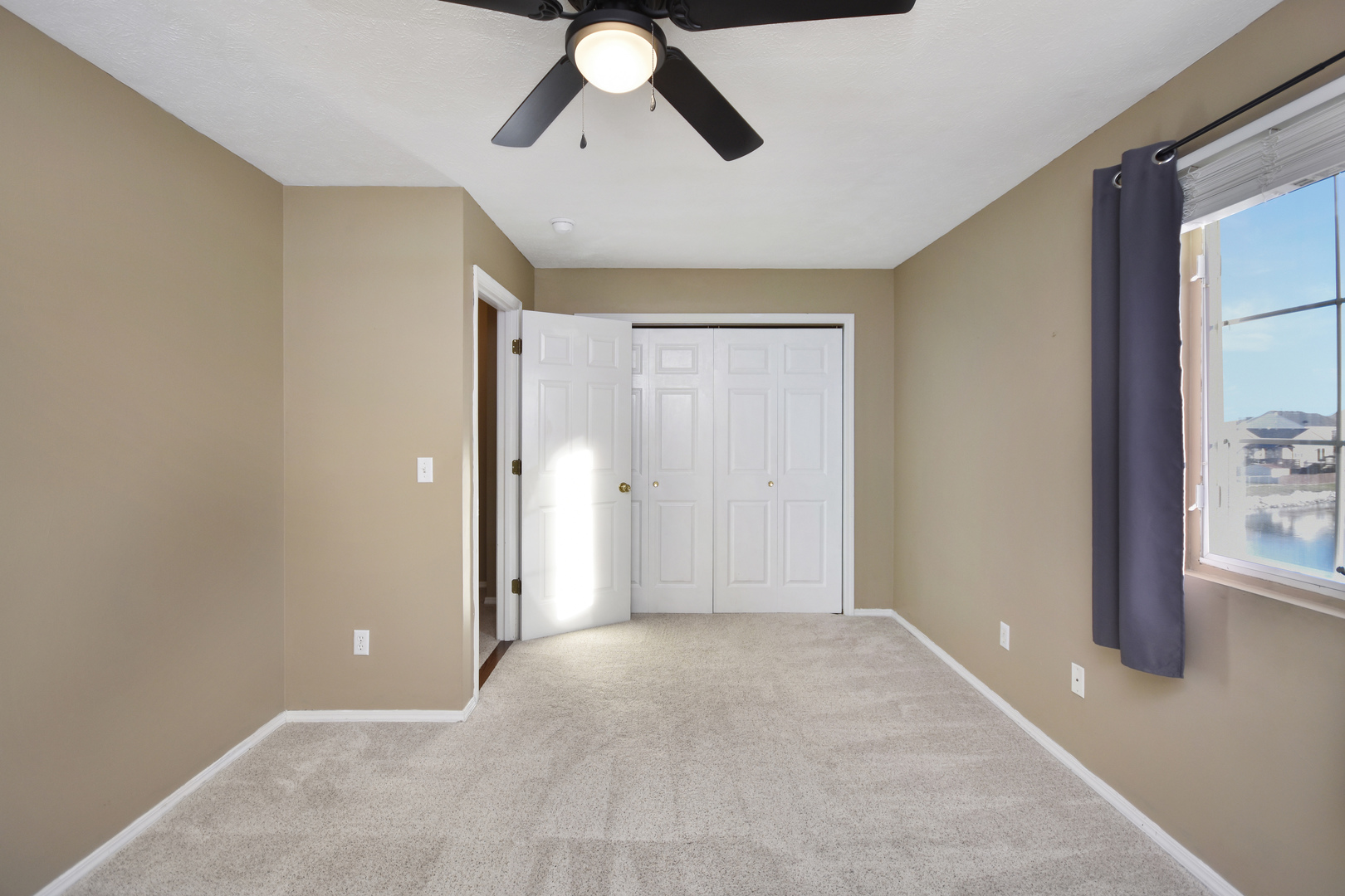 5 Andy Court, Unit 4 Bloomington, IL 61704 - Photo 30 of 52 a view of a livingroom with a ceiling fan