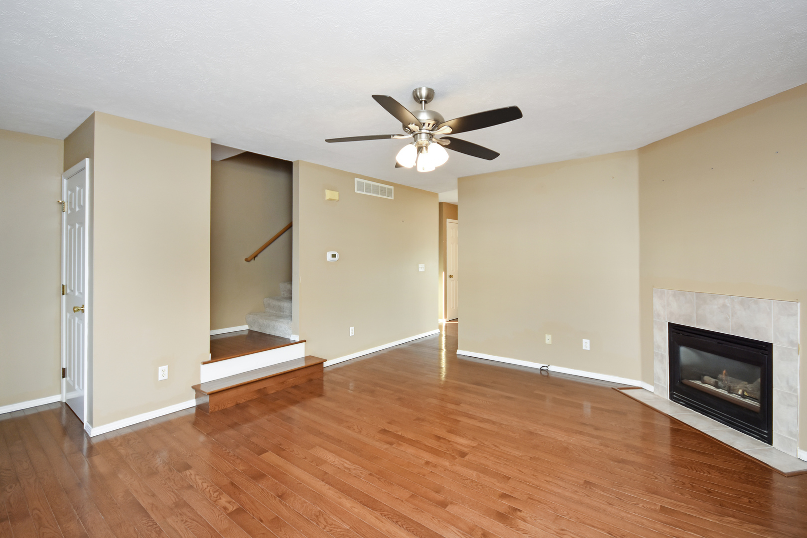 5 Andy Court, Unit 4 Bloomington, IL 61704 - Photo 8 of 52 wooden floor in an empty room with a fireplace