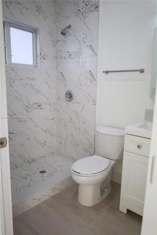 a bathroom with a toilet and a shower