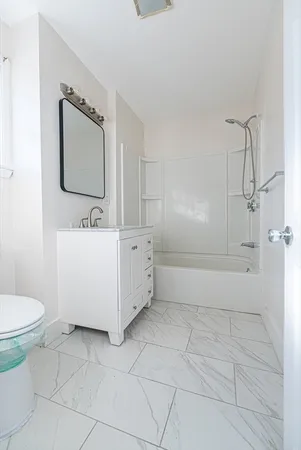 a bathroom with a sink a toilet and mirror